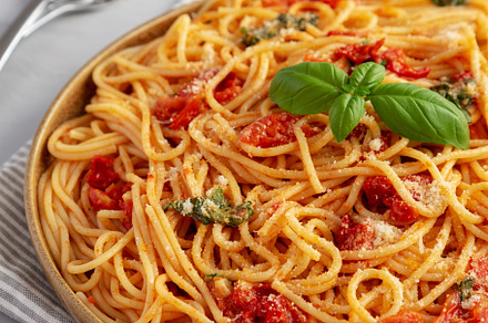 Homemade Spaghetti With Fresh Tomato Sauce on a Plate, side view, a Food & Drink Photo by LiudmylaChuhunova