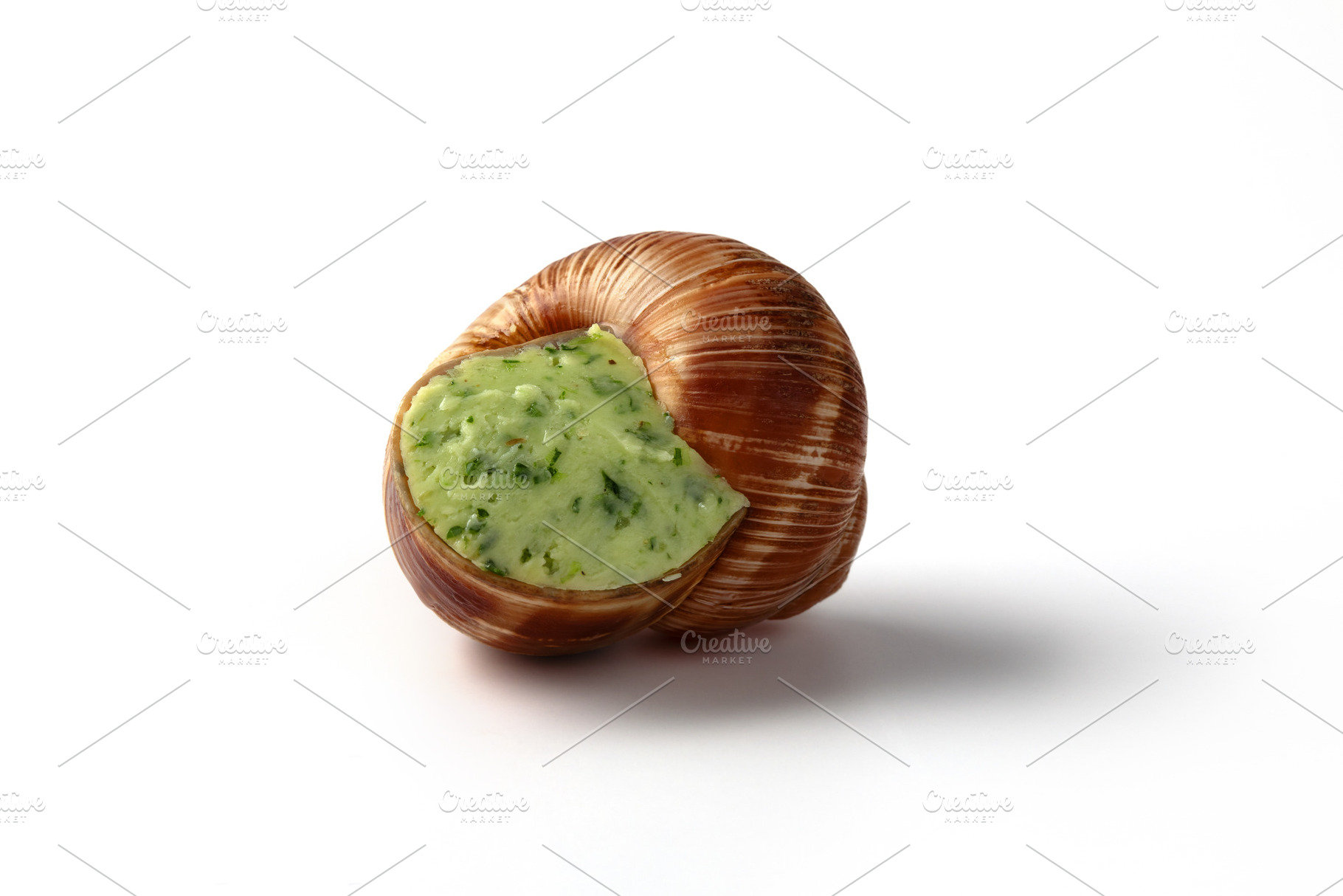 Closeup of a single escargot stuffed with creamy garlic herb but, a Food & Drink Photo by Ales Munt