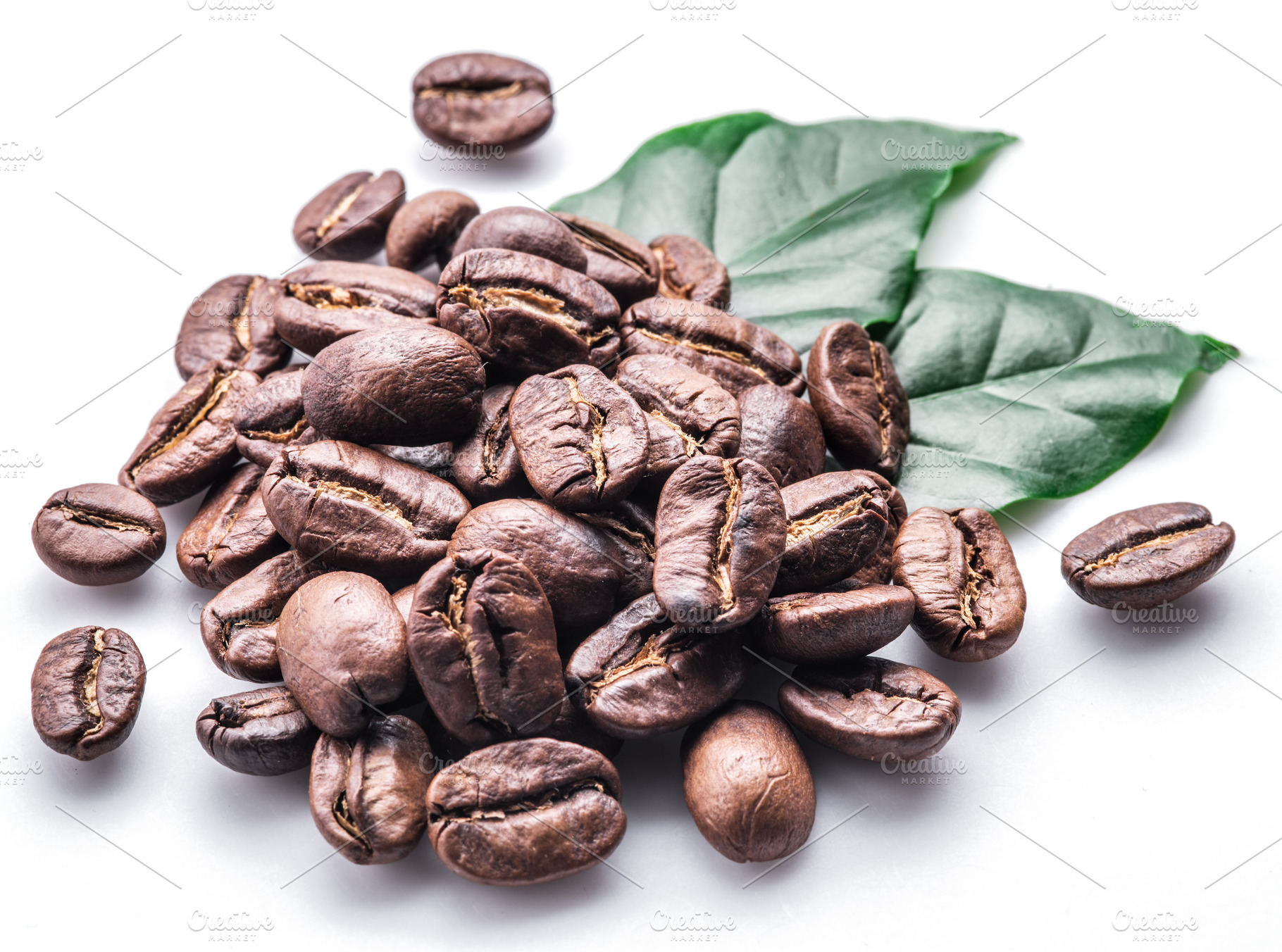 Roasted coffee beans and leaves on white background., a Food & Drink Photo by Volff