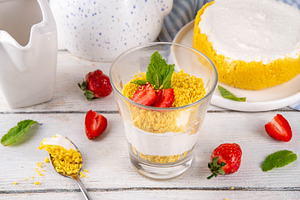 Classic cheesecake in glass, with fresh strawberry and golden co, a Food & Drink Photo by Rimma