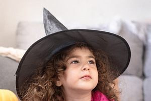 Little Girl in Witch Costume Looking Up Indoors, a Person Photo by etorres69