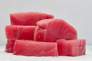 A stack of raw tuna pieces on a white board, a Food & Drink Photo by ndanko