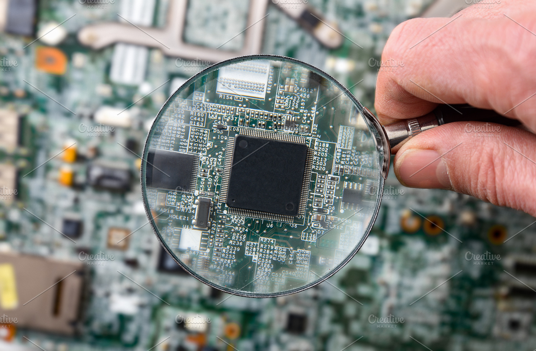 Hand Holding Magnifying Glass Over Microchip, a Technology Photo by Davizro's Market