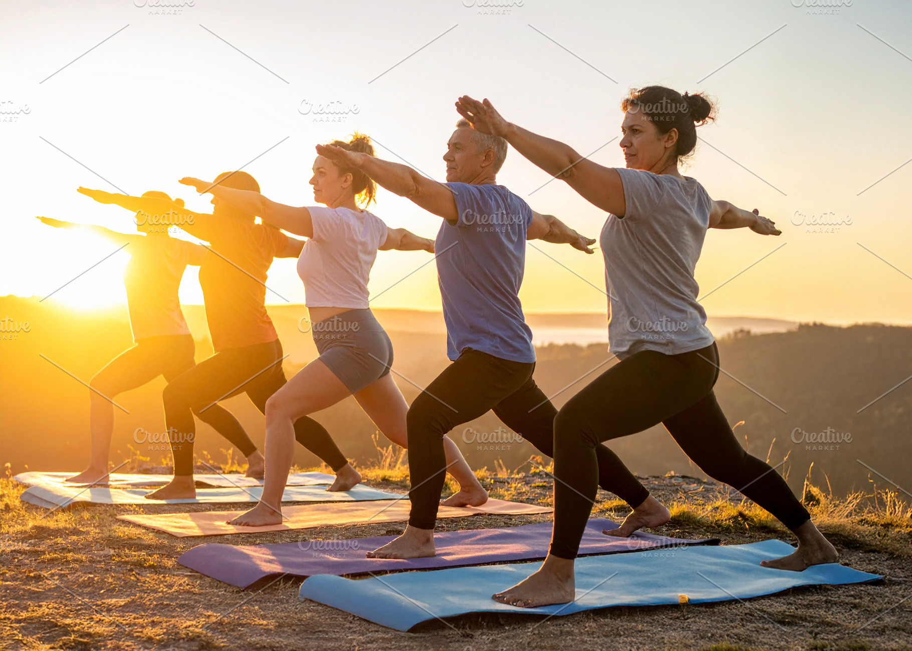 Diverse group practicing yoga at nature, a Health & Medical Photo by DanFLCreativo