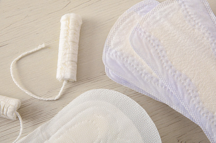 Background with female menstrual protectors on white wooden tabl, a Health & Medical Photo by Davizro's Market