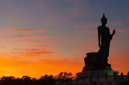 A majestic silhouette of Buddha statue against vibrant sunset sky, showcasing s, an Architecture Photo by a454