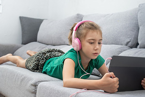 Young Girl Watching Tablet at home, a Person Photo by etorres69