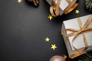 Christmas gifts and ornaments on black background, a Holiday Photo by Olena Rudo