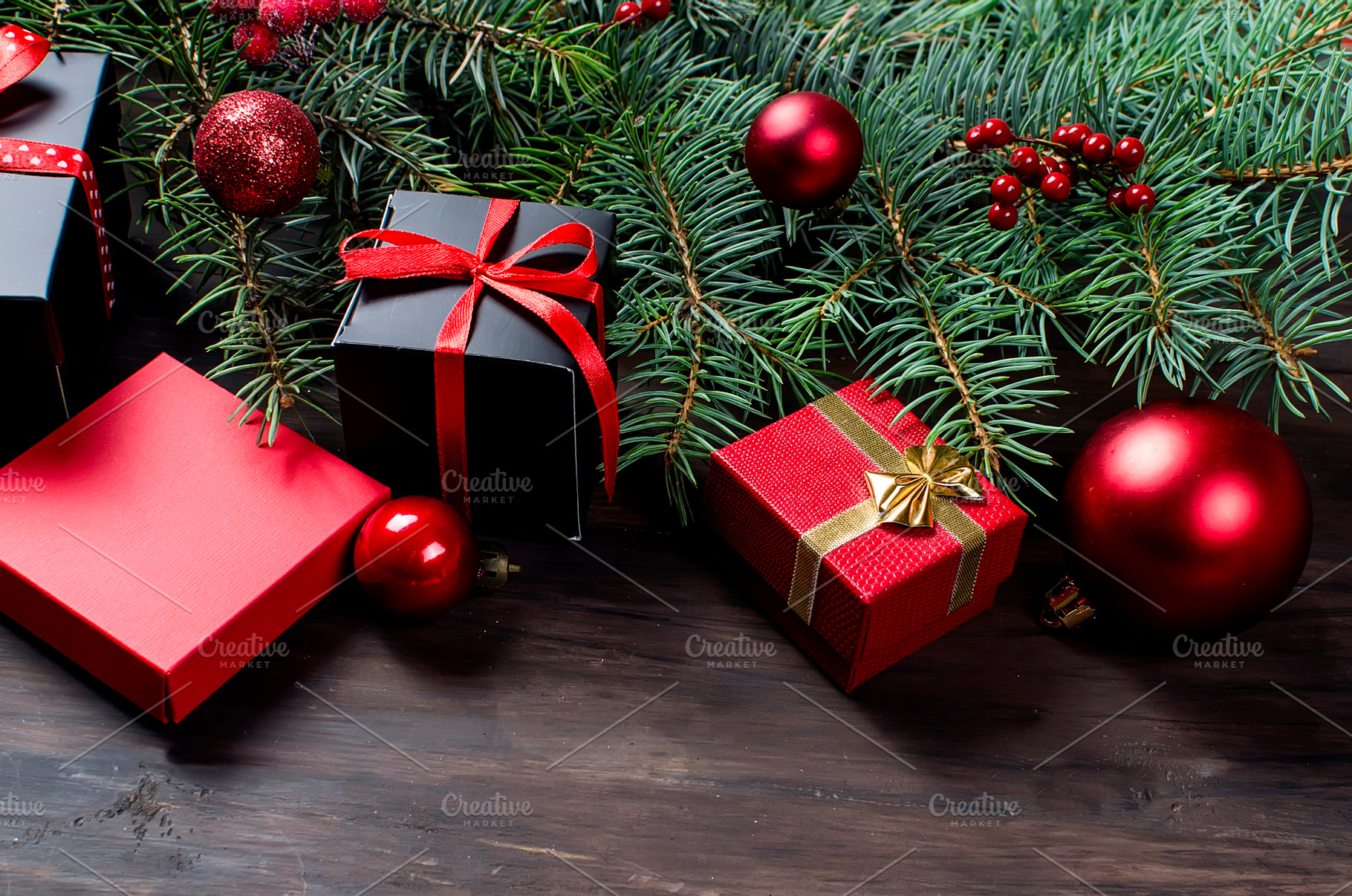 Black and red christmas gift box with red ribbon and fir bran, a Holiday Photo by vimart