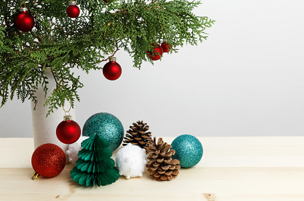 Vase with thuja branches, pinecones, and Christmas ornaments arranged for festi, a Photo by matucha