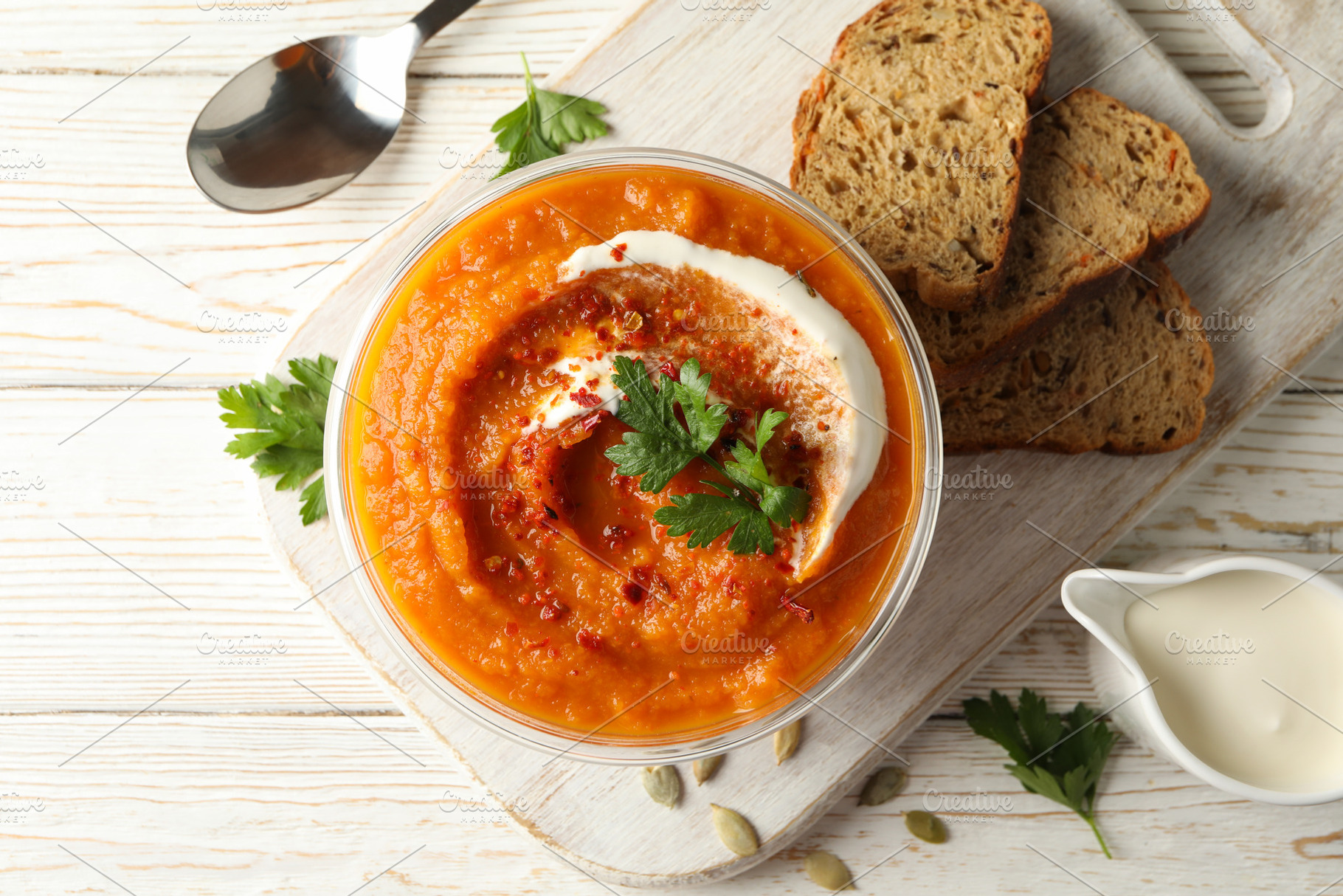 Composition with bowl of pumpkin soup on white wooden background, a Food & Drink Photo by AtlasStudio PRO