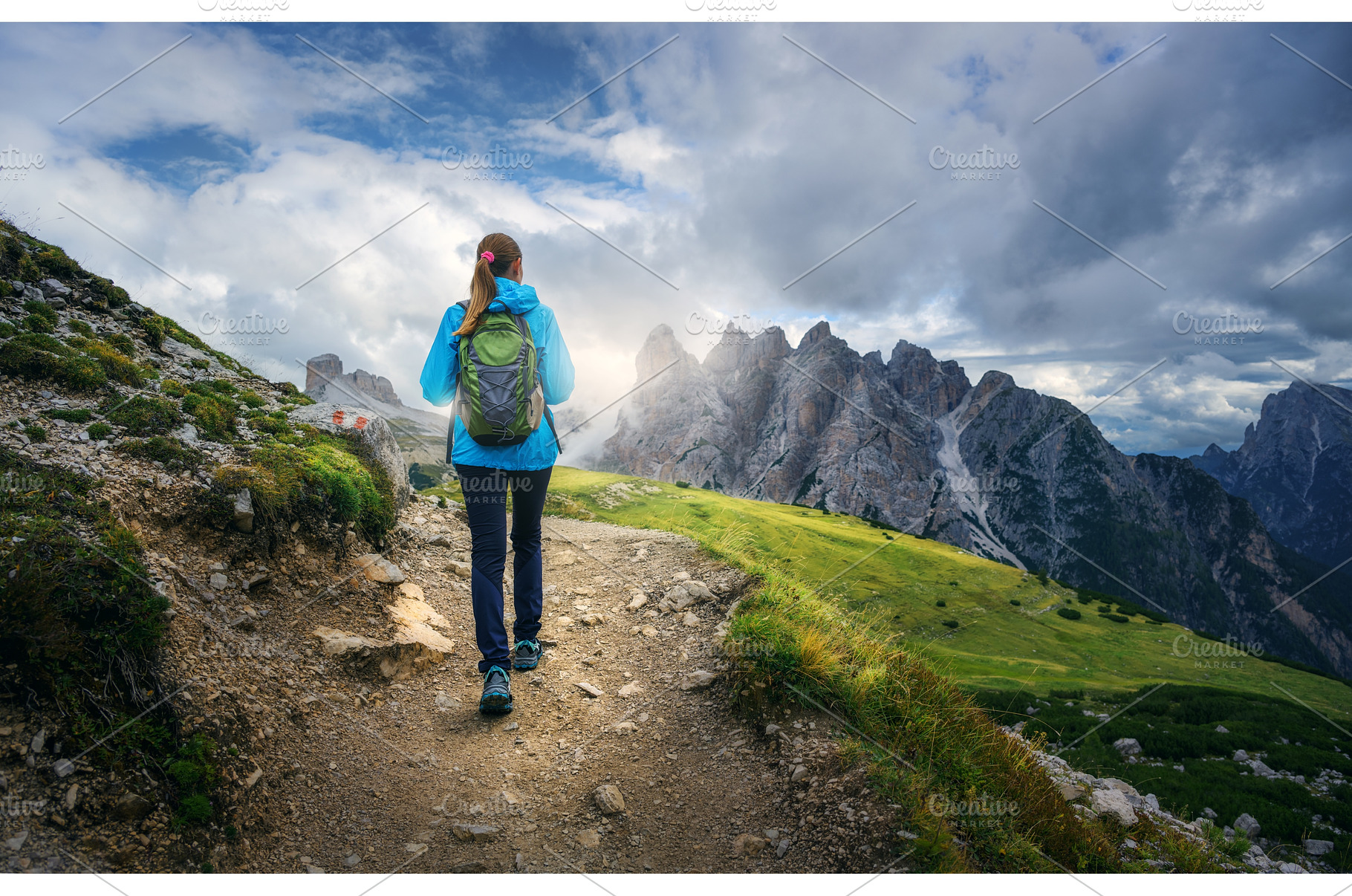 Female hiker walking on mountain, a Person Photo by den-belitsky