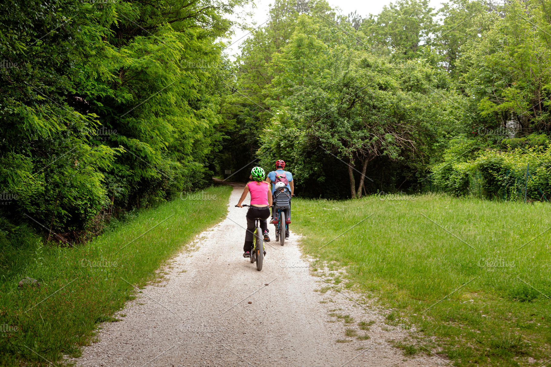 Young family riding bicycles in the park, a Sports & Recreation Photo by Bepslabor