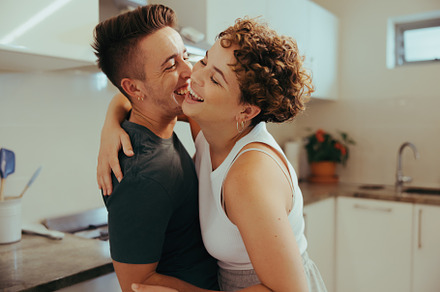 Queer couple laughing cheerfully in the kitchen, a Person Photo by Jacob Lund