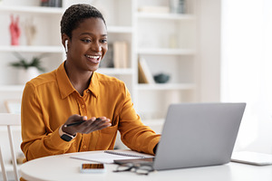 Young black woman having video conference with clients, copy space, a Photo by Prostock-Studio