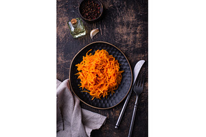 Spicy korean carrot salad in plate, a Food & Drink Photo by Yulia Furman