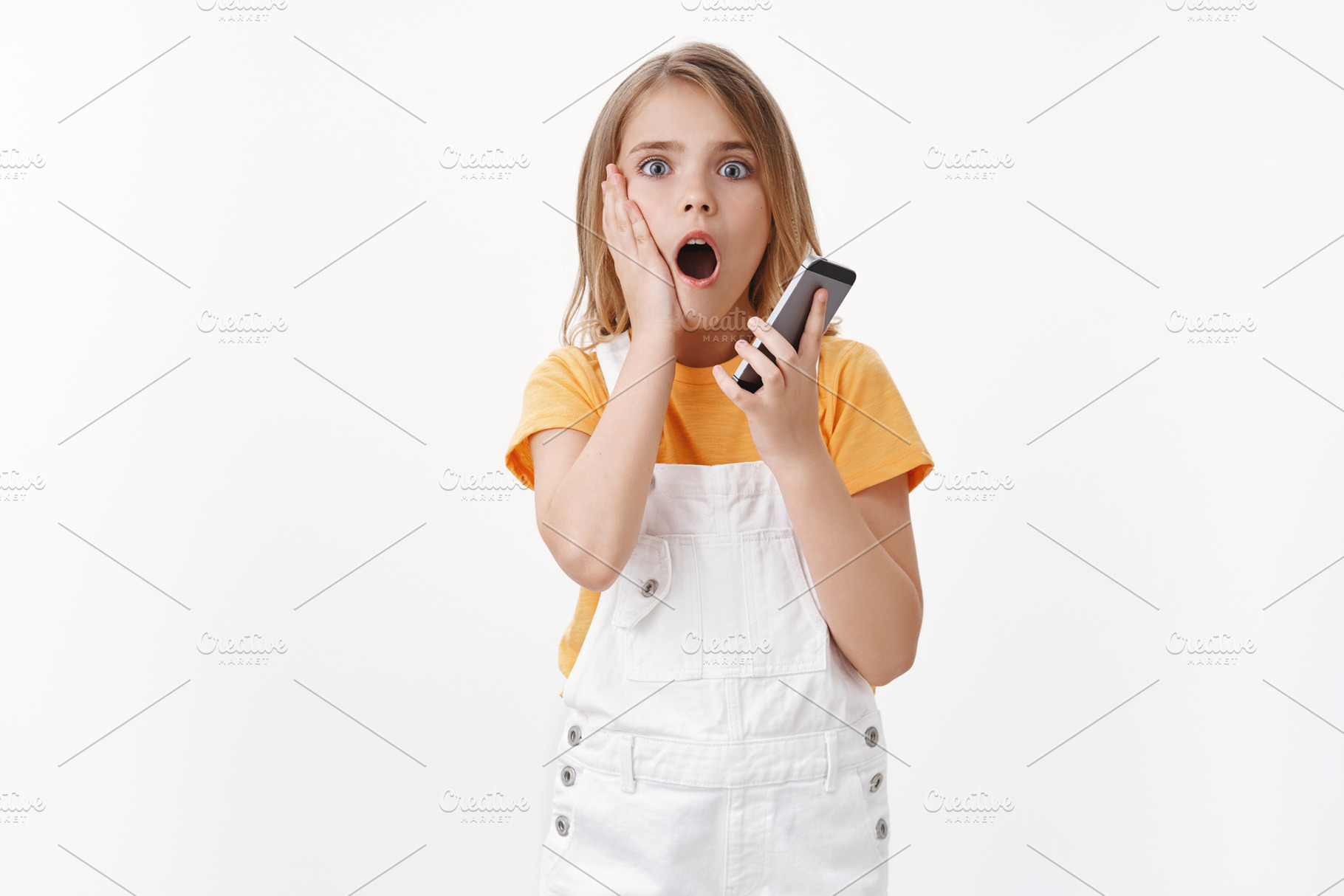 Shocked girl hold mobile phone, a Person Photo by Cookie Studio