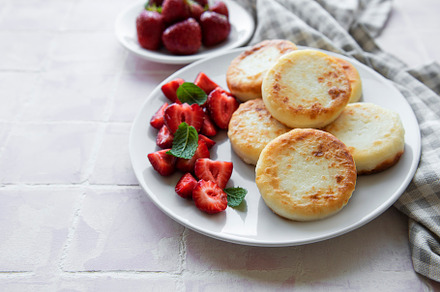 Cottage cheese pancakes, ricotta fritters on ceramic plate with, a Food & Drink Photo by Olena Rudo