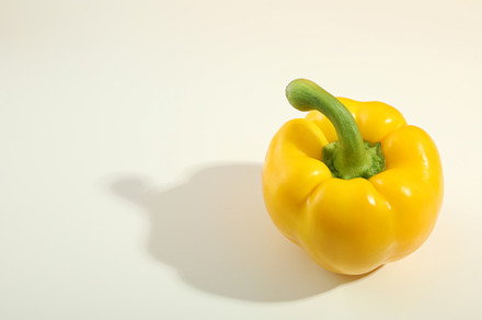 Yellow bell pepper on white background, space for text, a Food & Drink Photo by AtlasStudio PRO