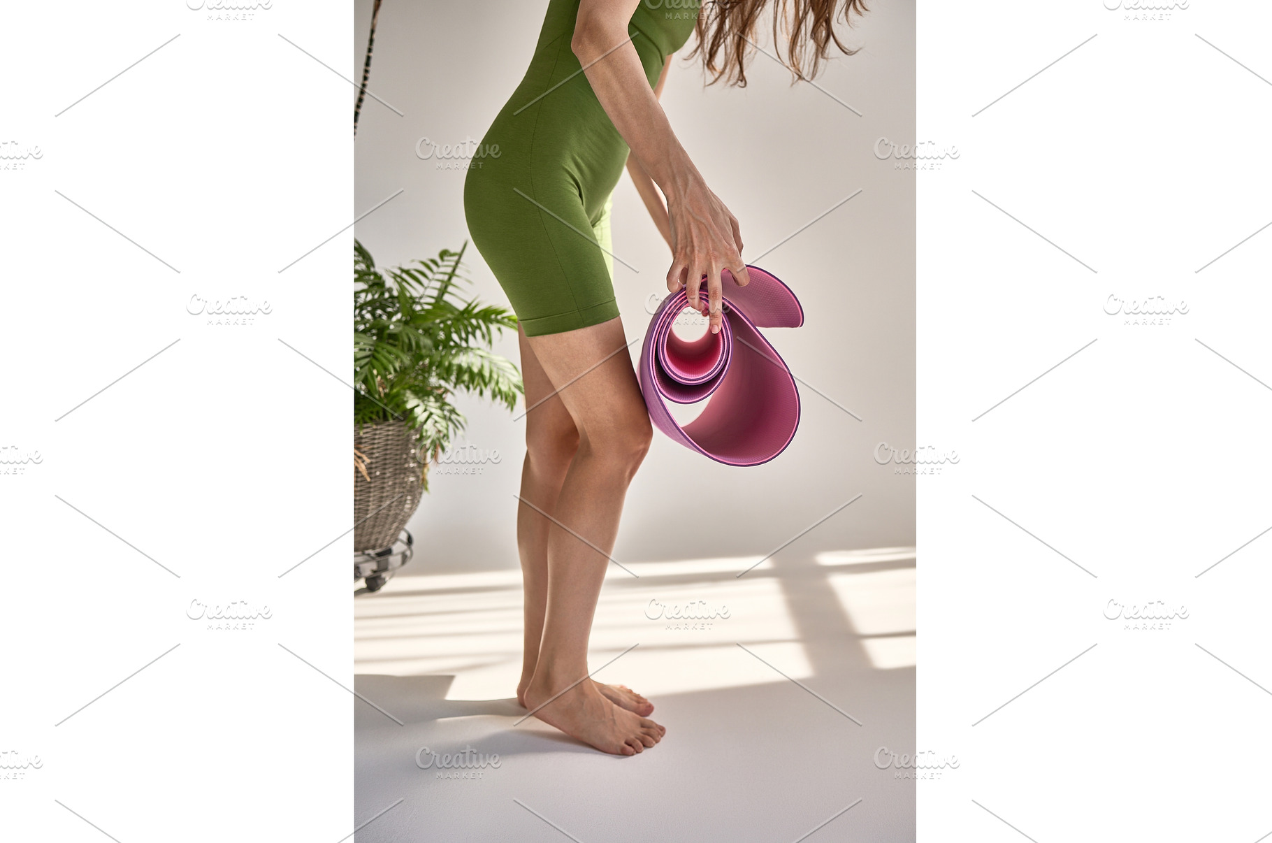 Woman in green athletic wear holding, a Person Photo by wip3out
