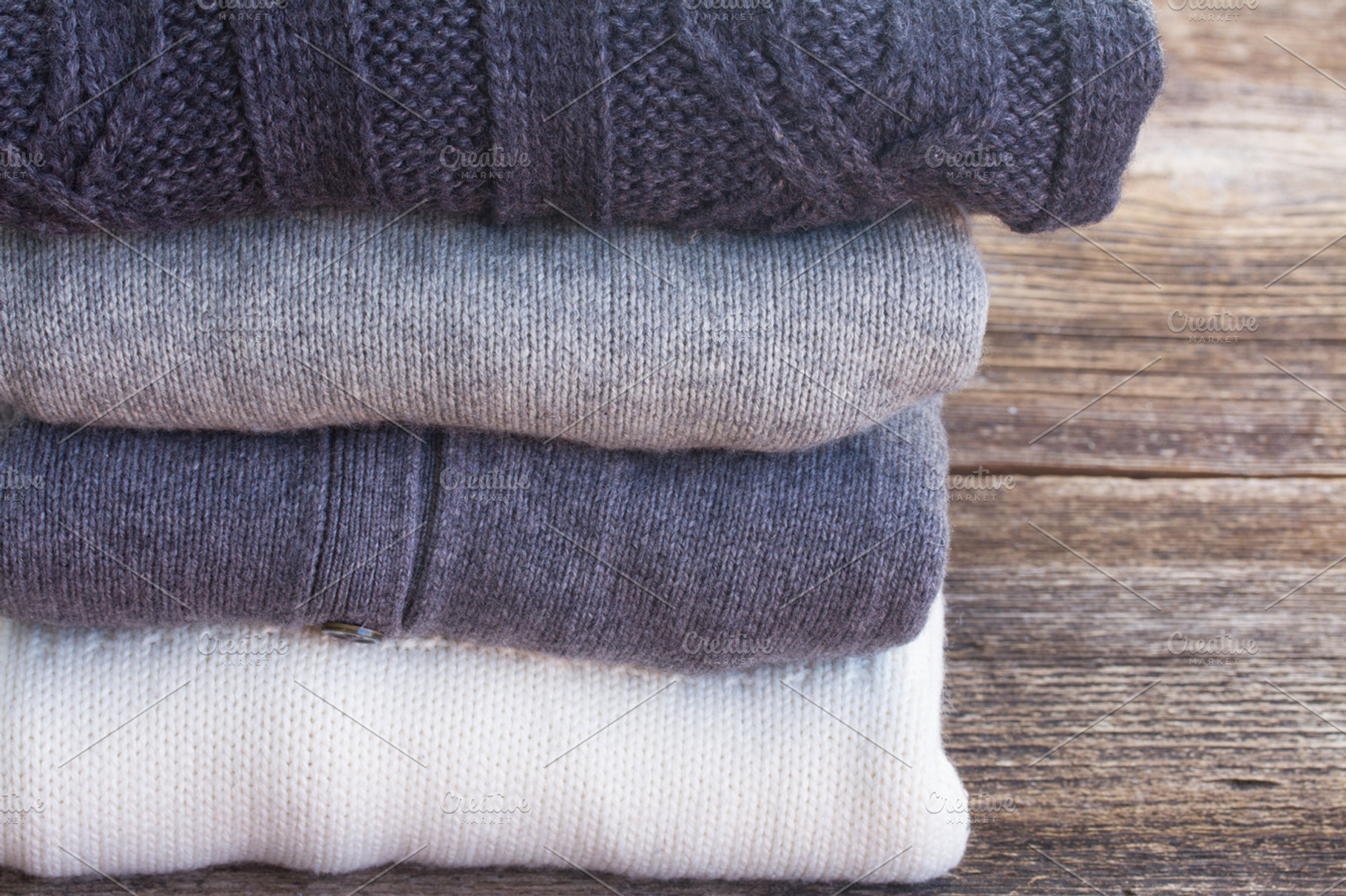 pile of woolen sweaters, an Abstract Photo by Neirfy