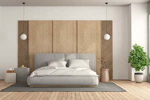 Minimalist bedroom with bed against wooden panel