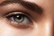 Female eye with shimmer bronze eyeshadow and bold groomed eyebro, a Beauty & Fashion Photo by Studio ANNA (Thumbnail 1 of 2)