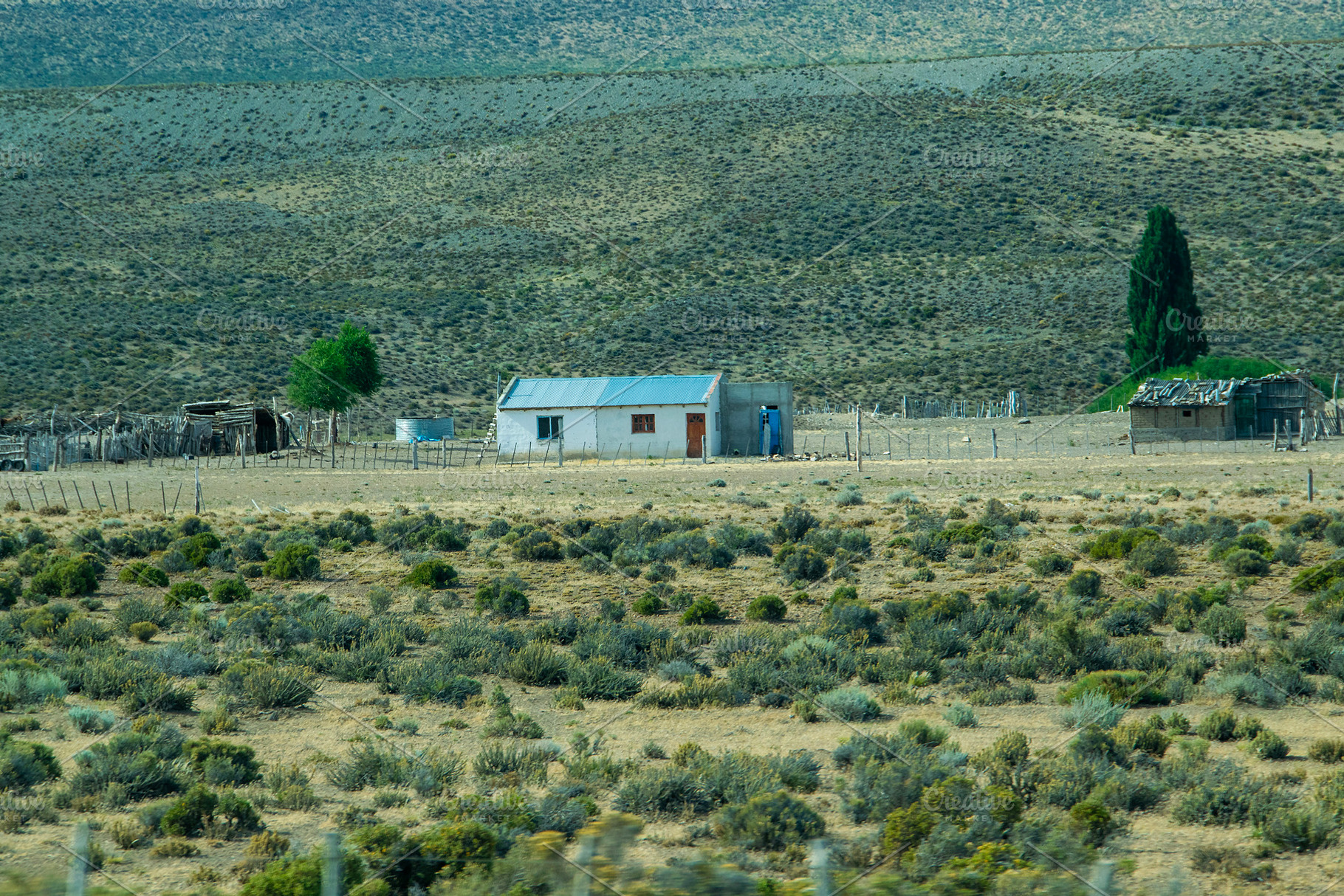 Rustic countryside house surrounded by the patagonian steppe lan, a Nature Photo by DanFLCreativo