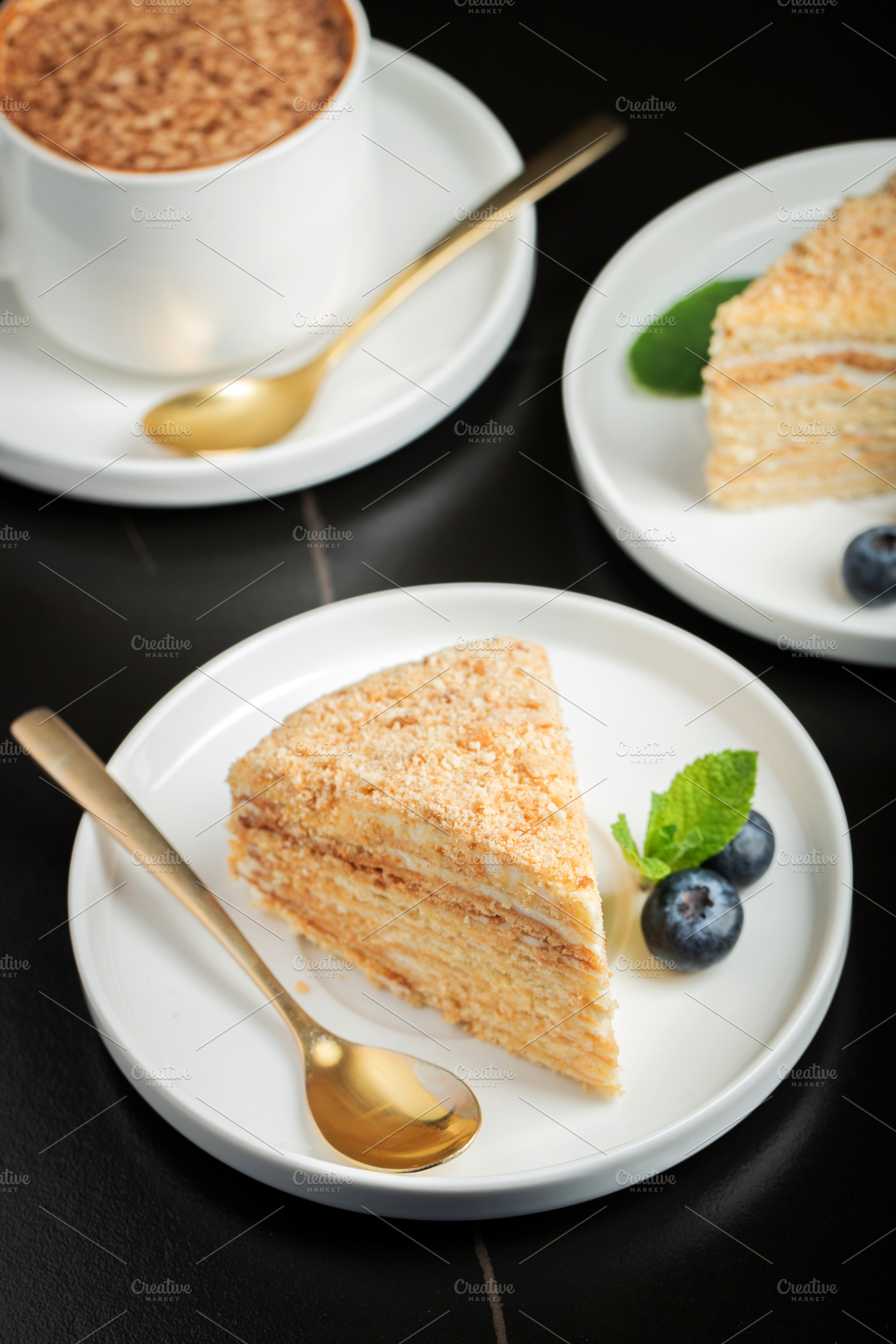 Medovik. Honey cake made from honey cakes with whipped sour cream, decorated wi, a Food & Drink Photo by Budarinphoto