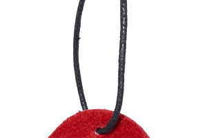 Red suede tag or label on a black cord, isolated background. Bla, a Business Photo by ndanko