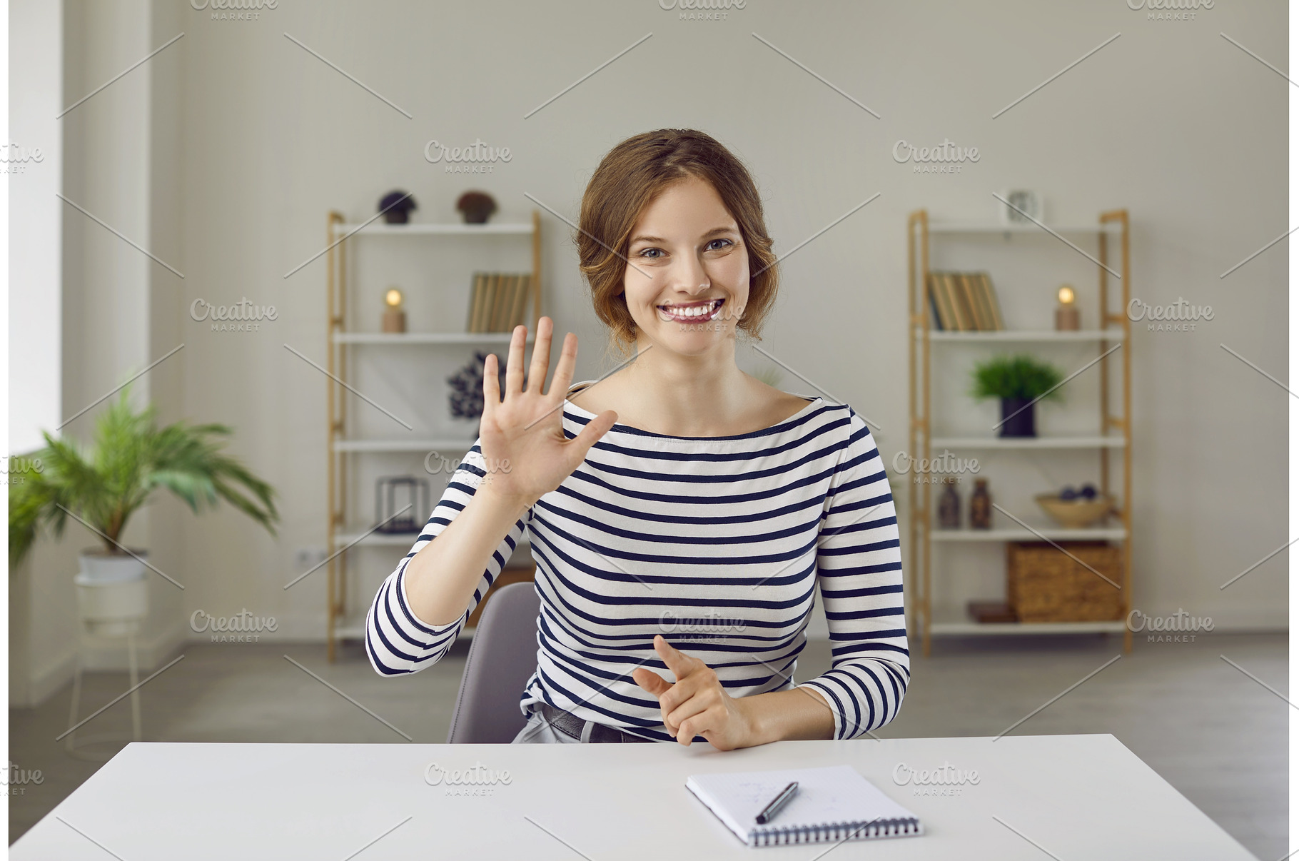 Portrait of woman smiling and waving, a Person Photo by StudioRomantic