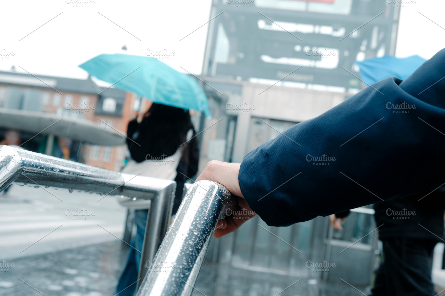 a man leaning on a wet railing in Copenhagen, a Photo by Nito