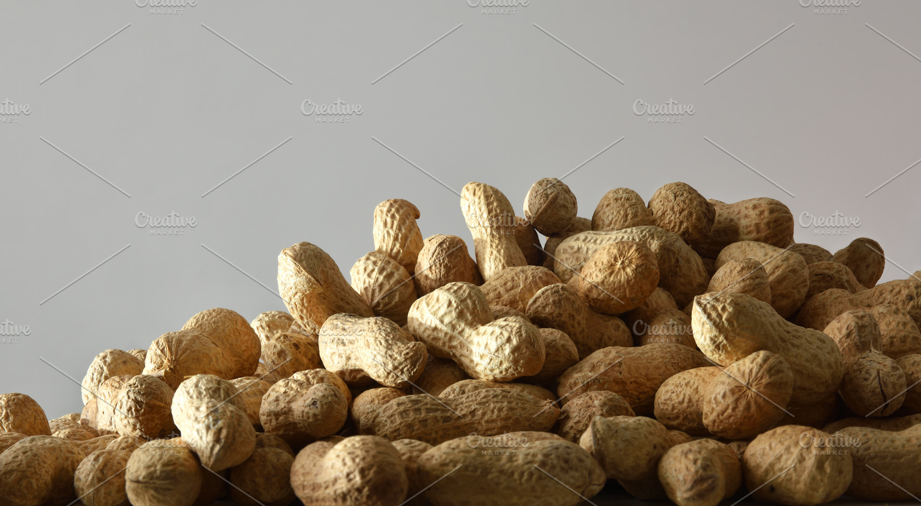 Pile of peanuts in shell isolated on a gray background, a Food & Drink Photo by Davizro's Market