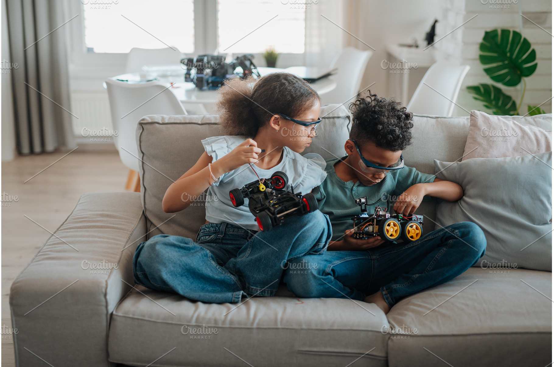 Siblings building robotic car at, a School & Education Photo by HalfPoint