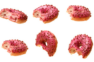 Bitten pink glazed donuts with berry sprinkles, shown from vario