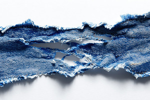 Torn denim fabric showing frayed edg, a Photo by Pavel_design