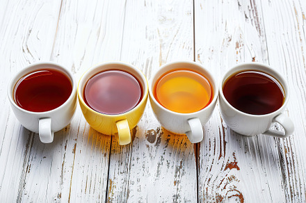 Different cups of aromatic tea on wooden table, a Food & Drink Photo by AlyaAnd