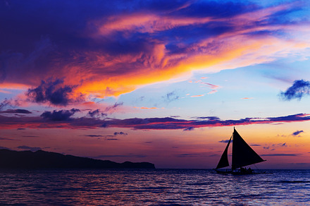 Colorful sunset at sea sailboat stock photo containing sunset and sailboat