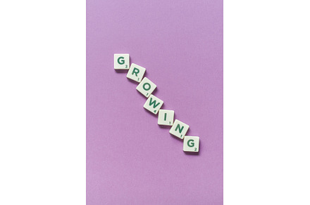 Growing formed of scrabble blocks on, a Business Photo by Yaroslav Danylchenko