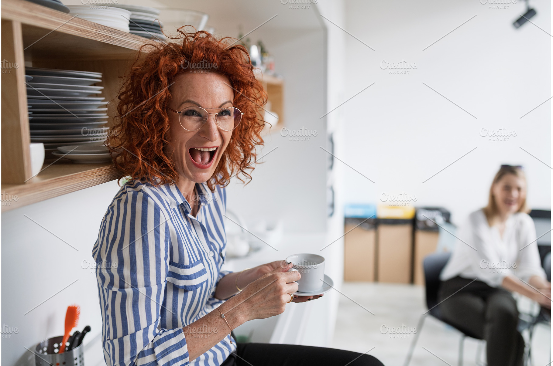 Mature businesswoman on coffee break, a Business Photo by HalfPoint