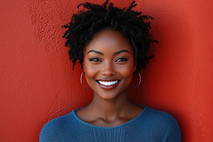 Confident woman in blue turtleneck sweater smiling in front of vibrant red wall, a Person Photo by José Manuel Gelpi