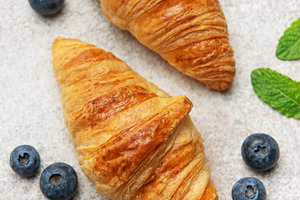 Delicious french croissants with fresh blueberries and mint on a, a Food & Drink Photo by Olena Rudo