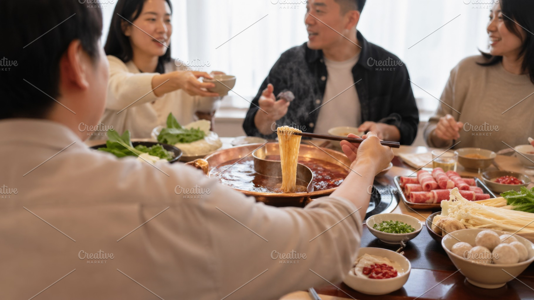 Hot pot party with friends enjoying, a Photo by Dvoevnore photos