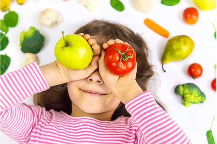 A child with vegetables and fruits, a Food & Drink Photo by yanadjana