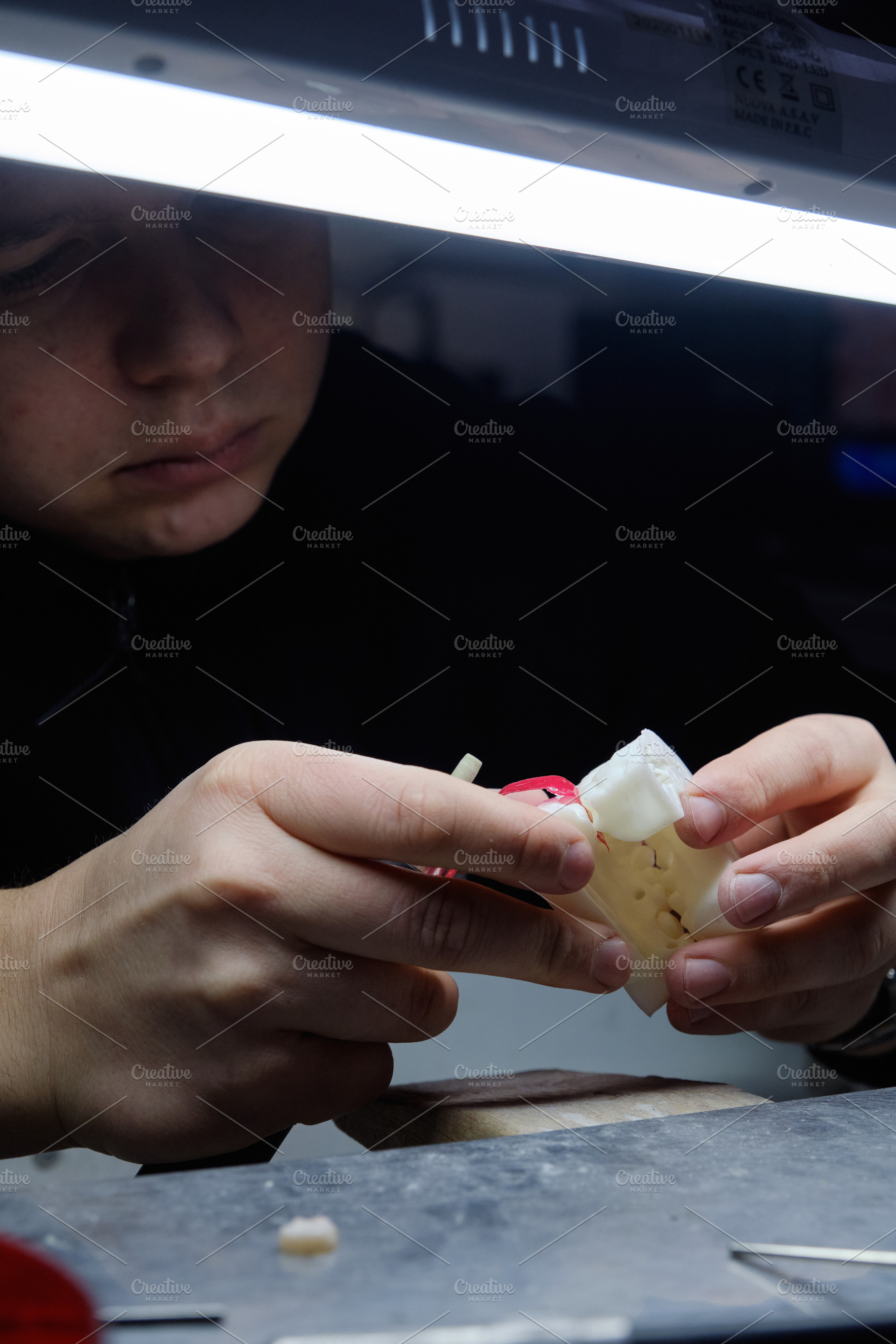 Close-up of a specialist performing accurate grinding on a high-tech dental moc, a Health & Medical Photo by Rohan Photography