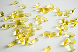 Many yellow gel capsules spread on, a Health & Medical Photo by volodymyrshtun13795