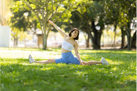A woman is doing a yoga pose in a