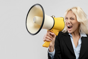 Angry irritated female businesswoman in formal wear screaming in megaphone and, a Photo by Prostock-Studio