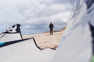 Woman preparing kite for surfing stock photo containing outdoor and sport