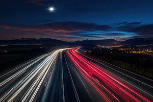 City lights and moving cars at night, a Photo by Beautiful things